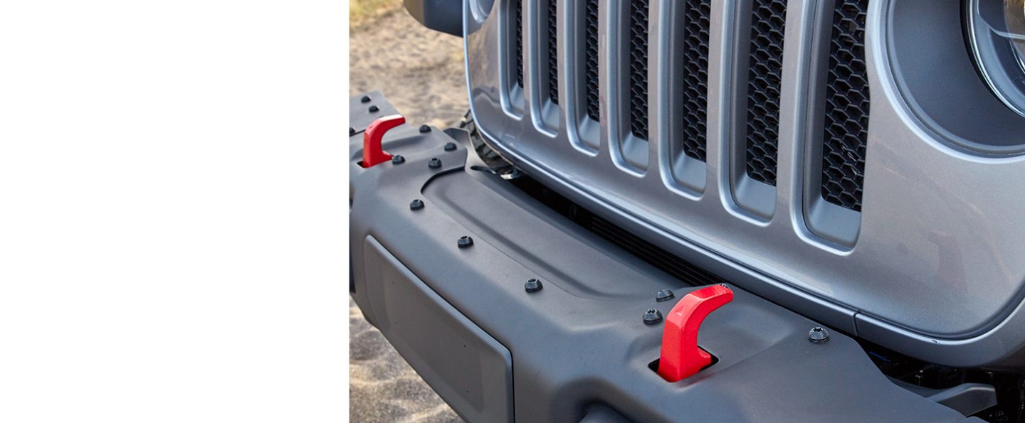 The red tow hooks and the grille on the front of the 2020 Jeep Wrangler Rubicon.